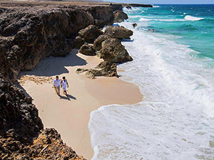 couple walking on a Caribbean beach