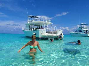 woman standing by a boat in the Caribbean