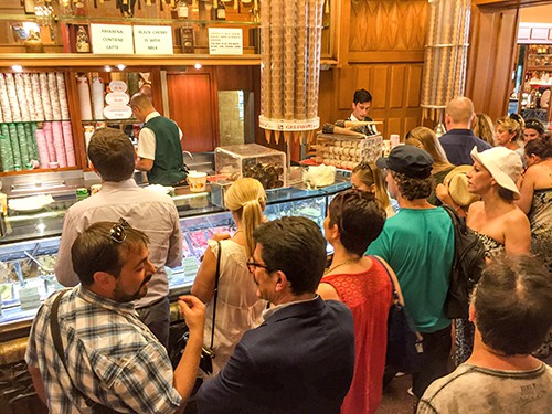 people at a counter ordering the best gelato in Rome
