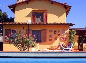 a man reading by a pool in Italy