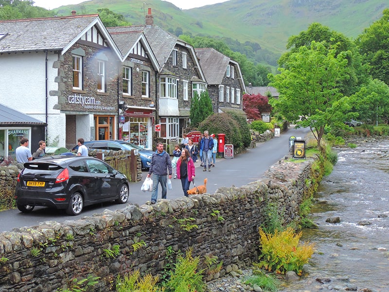 people walking through a country town in England