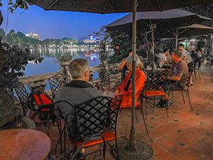 people sitting at a cafe table in Hanoi