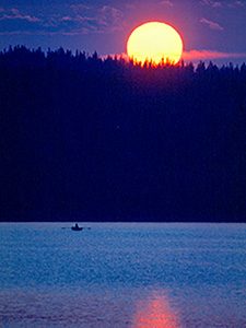 a rowboat on a lake at sunset in Scandinavia