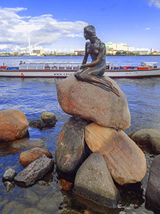 a statue on the water's edge in Copenhagen