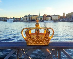 a crown on a fence by a harbor in Scandinavia
