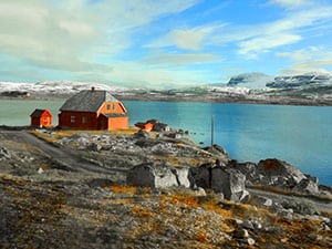 a red house on a lake in Norway in Scandinavia