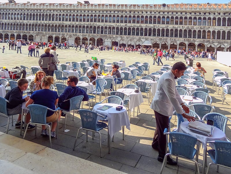 cafe tables in a large square in one of the best places to visit in Venice