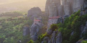 monasteries on a cliff at sunsel