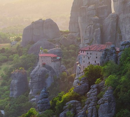 monasteries on a cliff at sunsel