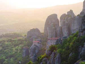 monasteries on a cliff at sunsel in Meteora