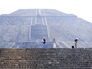 people near an ancient pyramid seen on a day trip from Mexico City