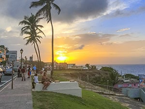 walking along a coastal street at sunset - one of the things to do in Old San Juan