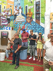 joining people at a party brightly painted wall in San Juan - one of the things to do in Old San Juan