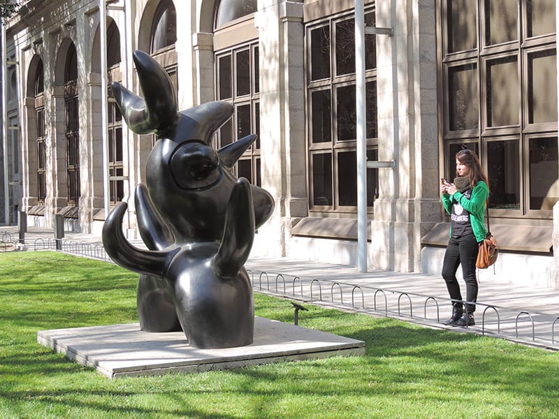 a woman in a sculpture garden