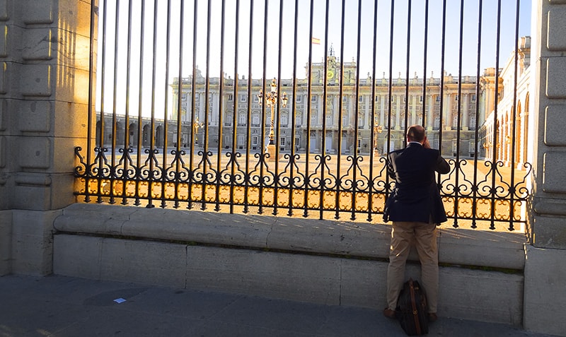 Man looking at the Palacio Real, one of the things to do in Madrid