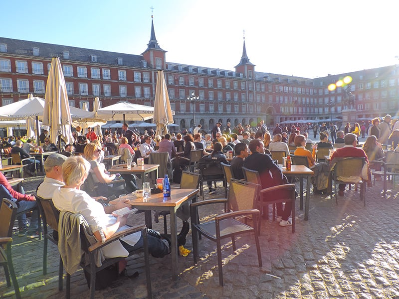people in cafes in the Plaza Mayor, one of Madrid's top places