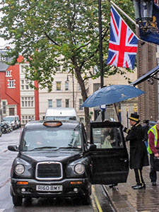 a British flag over a cab - how to save on hotels