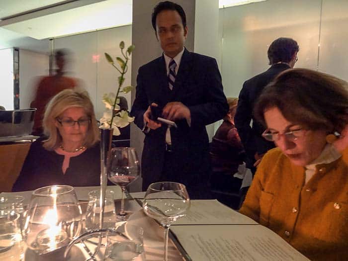 Women looking at menus in the restaurant The Modern, one of the best restaurants in New York City museums