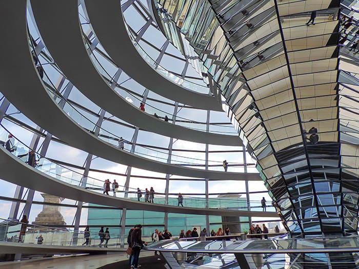 people walking inside the glass dome of the Reichstag, one ofThe Best Things To Do In Berlin, Germany