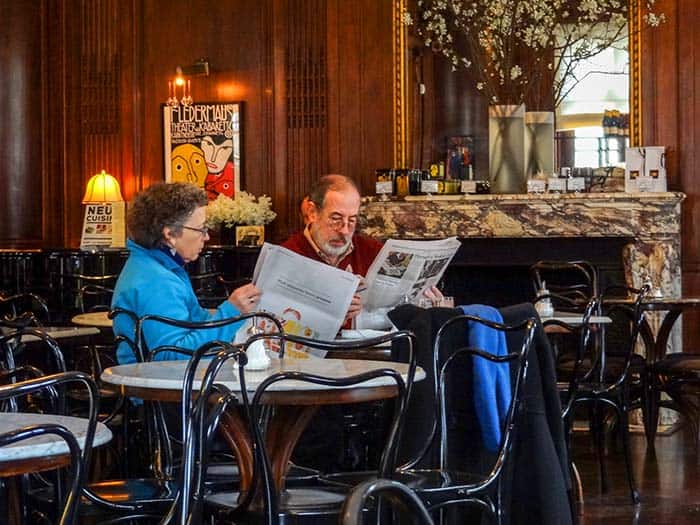 couple reading newspapers in one of the best restaurants in New York City museums