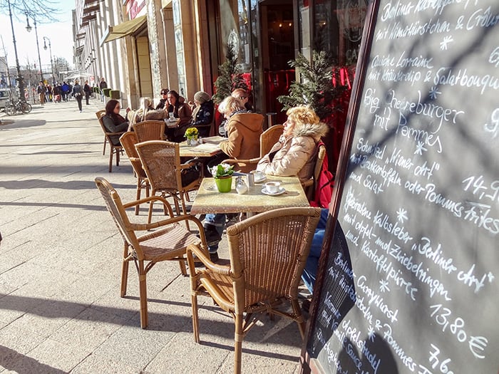 people at an outdoor cafe on the Unter den Linden, one of the best things to do in Berlin, Germany