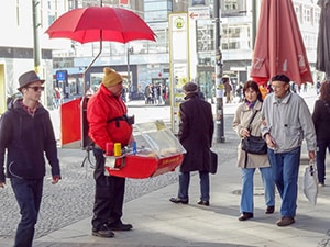 people buying currywurst from a street vendor, one of The Best Things To Do In Berlin, Germany