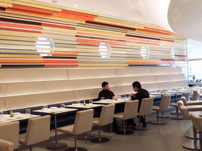 two men in a modern restaurant in the Wright Restaurant, one of the best restaurants in New York City museums