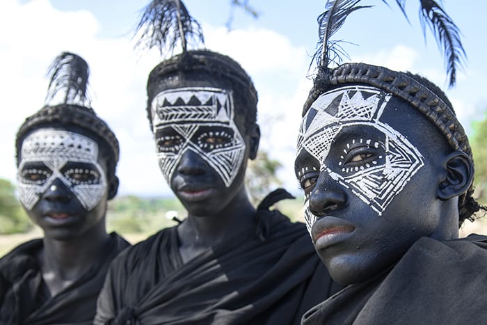 boys with faces painted black in Tanzania