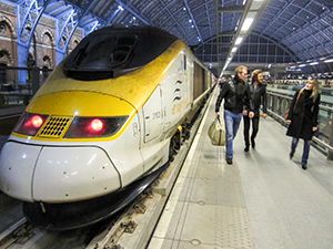 people waling by a train - new traevler