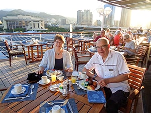 a couple eating a meal on the deck during a Pacific cruise