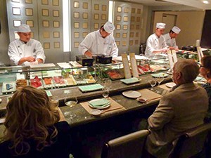 Sushi chefs with patrons