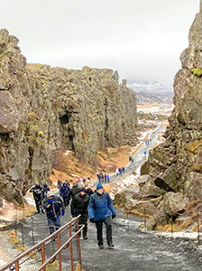 people on a path in a canyon on an Iceland tour