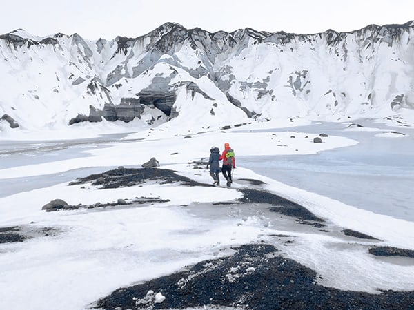 people walking across the snow - Iceland ice caves