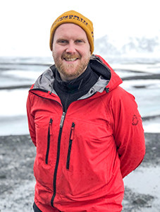 a tour guide in a red jacket