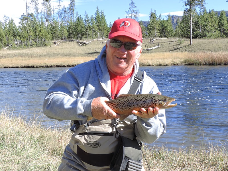 a fisherman with his catch seen on a Yellowstone family vacation