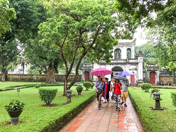 people with umbrellas - best city in Vietnam