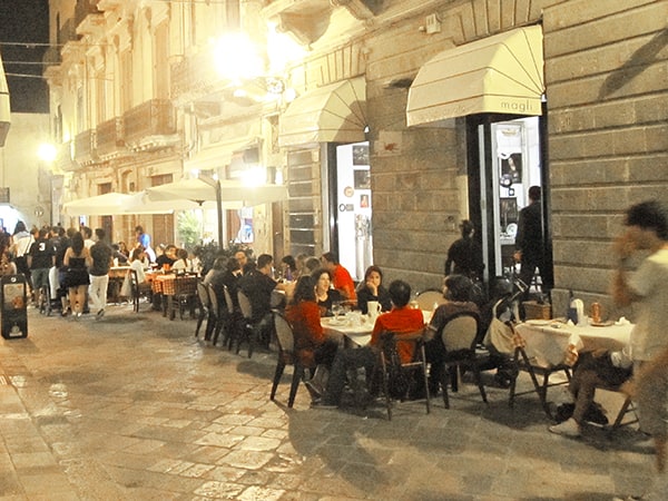 people at outdoor restaurant top 10 in Italy