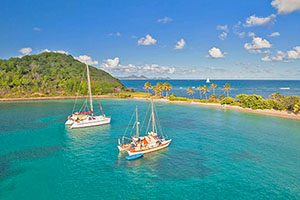 sailboats by an island Silversea Muse