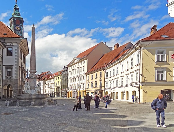 people walking through an old town