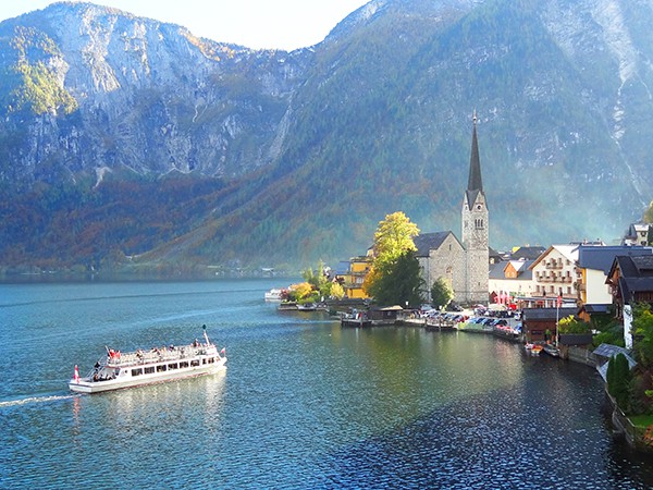 a boat approaching a lakeside town