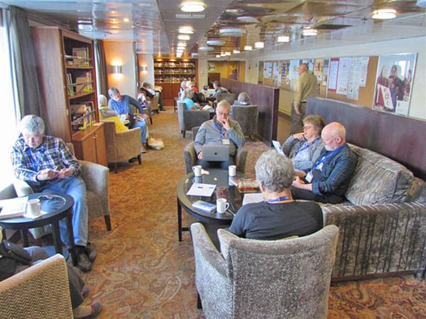 people relaxing on a ship sailing through the Scottish islands