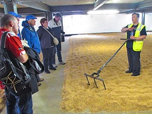 a man showing how to ra barley