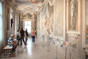 people looking at frescos in Friuli