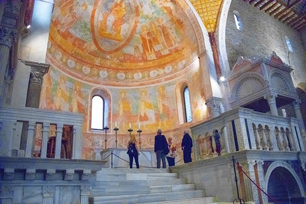 people looking at frecose in a church