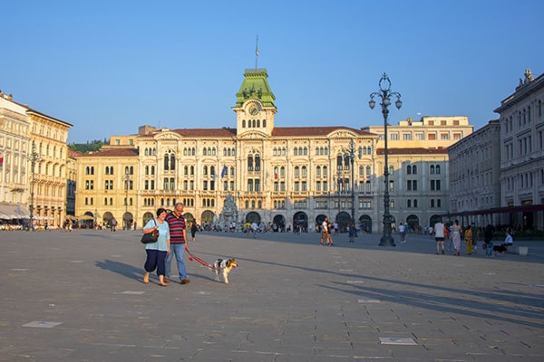 couple walking a dog in Trieste