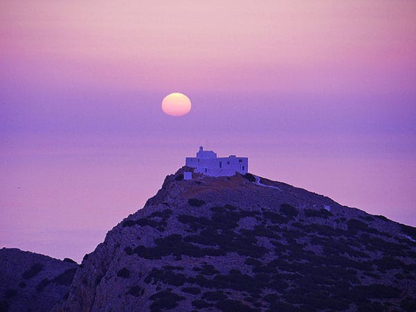 a church on a hilltop at sunset