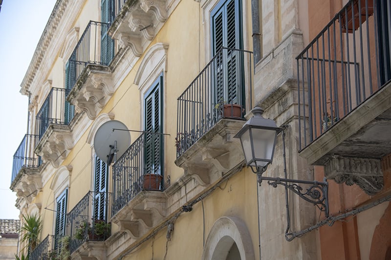 old balconies on a building - cities in Sicily