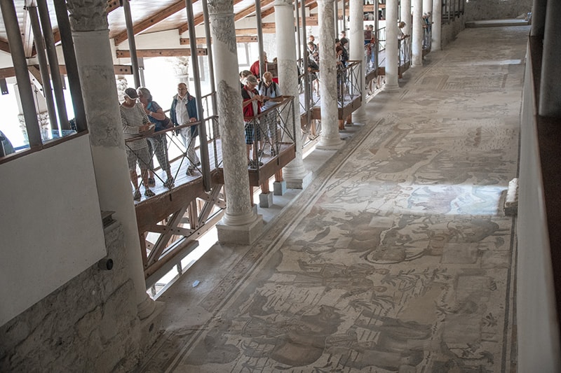 people looking at mosaics - cities in sicily