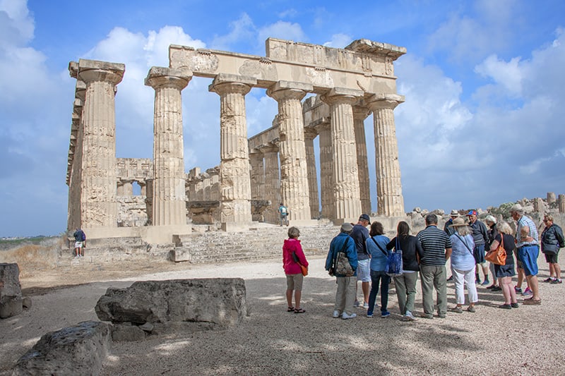 people looking at a greek temple - Mt. Etna