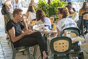 people in a cafe - tour of sicily